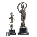 A silver motor racing trophy in the form of a classical figure blowing a horn, on turned wooden case