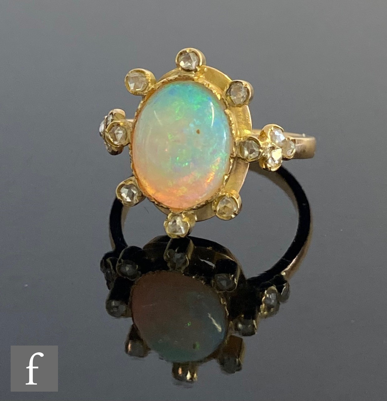 A 18ct opal and diamond cluster ring, central collar set oval opal, length 10mm, within a border