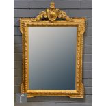 A 19th Century gilt wall mirror of raised beaded decoration with scroll shield and pediment mount,