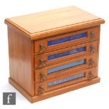 An Edwardian satinwood four drawer sewing cabinet, named Celebrated Redditch Needles on plinth