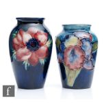 Two small Moorcroft vases, the first decorated in the Anemone pattern, the second the Frilled Orchid