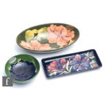 Three pieces of Moorcroft Pottery comprising a rectangular pen tray decorated in the Anemone