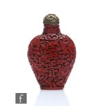 A Chinese 19th Century carved Cinnabar lacquer snuff bottle, the metal flattened ovoid form metal