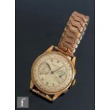 A mid 20th Century 18ct Swiss chronograph wrist watch with twin subsidiary dials, silvered dial,