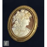 A 19th Century gold mounted oval cameo brooch head and shoulder profile of a young woman with
