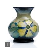 A small Moorcroft Pottery vase decorated in the Hypericum pattern designed by Rachel Bishop,