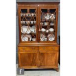 A 19th Century mahogany and line inlaid bookcase enclosed by a pair of swept bar glazed doors