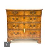 A late 18th to early 19th century cross-banded walnut and chequer strung inlaid straight front chest