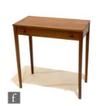 A post war teak side table circa 1970, fitted with a single drawer with turned handles above tapered