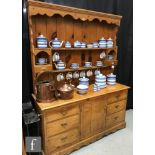 A 19th Century pine dresser the later rack over a cupboard base and six drawers, on shaped plinth