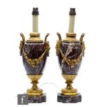 A pair of 20th Century French gilt metal mounted serpentine table lamps, applied with horned