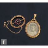 An early 20th Century 9ct oval open locket with a 9ct garnet and seed pearl oval brooch, total