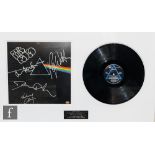A Pink Floyd Dark Side of the Moon montage, to include an LP signed Nick Mason, Roger Waters,
