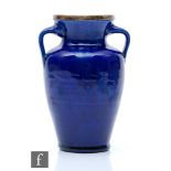 A small Baron of Barnstable pottery vase of shouldered form with twin handles in a deep blue glaze