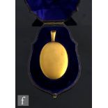 A cased 19th Century 15ct oval locket of plain form opening to a portrait miniature of a lady and