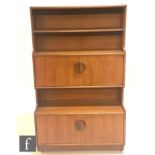 A post war Danish teak side cabinet circa 1970, with open shelves above a central double door