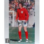 A collection of five signed 1966 World Cup final photographs to include Martin Peters, George Cohen,