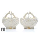 A pair of late 19th to early 20th Century posy baskets, the blanc de chine bodies with moulded