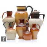 Seven assorted salt glazed jugs of varying form, S/D.