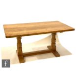 A late 20th Century oak twin pedestal refectory dining table from the workshop of Robert '