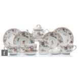 A 1920s Royal Worcester tea for two decorated in a Chinoiserie pattern with vases of flowers and