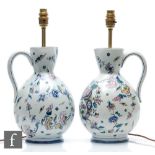 A pair of Gien French Faience jugs, each decorated with a cornucopia of flowers, floral sprays and