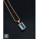 An 18ct aquamarine pendant, emerald cut stone, length 16mm, claw set to a plain mount, suspended