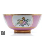 A large footed bowl decorated to the interior and exterior with handpainted sprays of flowers