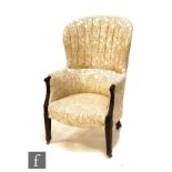 An Edwardian mahogany horseshoe back easy chair on square tapering fluted legs to the front,