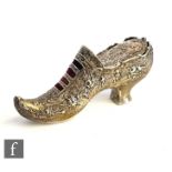 An early 20th Century hallmarked silver pin cushion modelled as a lady's shoe with embossed