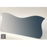 An Art Deco frameless wall mirror of elongated tulip outline, unlabelled, height 54cm and width