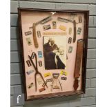 A vintage barber shop wall montage, the glazed wooden case containing cut throat razors, clippers,