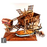 A wooden scale model of a four wheeled Tumbrel cart, length 85cm, a similar hay cart and tools, a