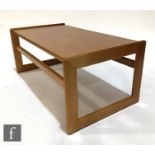 A 1970s teak coffee table of rectangular form, raise to strut type supports, unlabelled, height
