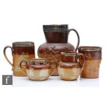Four pieces of early 20th Century Doulton salt glazed stoneware comprising a beaker, cider mug, milk