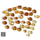 Thirty five loose cut and polished citrine and mandarin citrine to include oval, round and canted