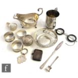 A small parcel lot of assorted hallmarked silver items to include a christening mug, a sauce boat,