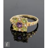 A 9ct hallmarked amethyst, peridot and seed pearl cluster ring, central amethyst within