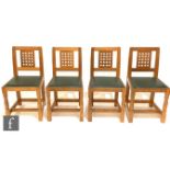 A set of four late 20th Century oak lattice back dining chairs from the workshop of Robert '