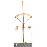 A post war sculptural wall hanging in the form of an archer's bow, mounted with arrow shafts,