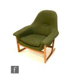 A post war armchair or easy chair, in moss green hopsack style upholstery over a teak sledge style