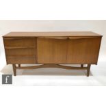 An early 1970s teak sideboard in the manner of McIntosh, fitted with an arrangement of three drawers