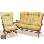 An Ercol Furniture beech framed model 203 Windsor bergere two-seat settee or sofa, together with a