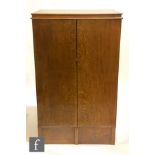 An early 20th Century oak collectors cabinet fitted with twelve sliding drawers, some glass