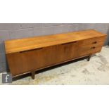 A 1970s teak veneered sideboard in the style of A. Younger, fitted with a double door cupboard