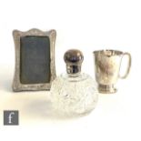 A Sterling silver half pint tankard of plain form with circular stepped foot and C scroll handle,