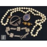 A small parcel lot of jewellery to include a row of cultured pearls, a gold brooch, a silver