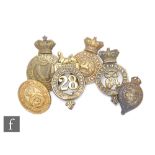 A collection of six brass cap badges to include Connaught Rangers, North Gloucestershire,