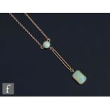 An Edwardian 9ct two stone opal pendant, canted rectangular drop below a pierced bar and circular