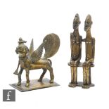 Two seated Benin style bronze figures, height 13cm, and a Indian brass Griffin style figure. (3)